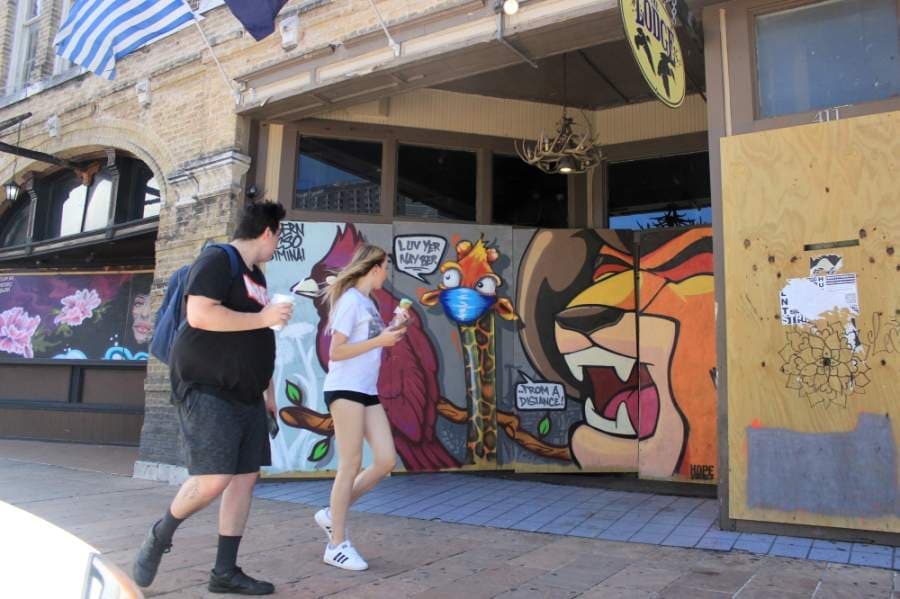Many bars on Sixth Street remain boarded up, and some were painted by artists from the HOPE Outdoor Gallery. On May 18, Gov. Greg Abbott announced that bars could reopen on May 22. (Jack Flagler/Community Impact Newspaper)