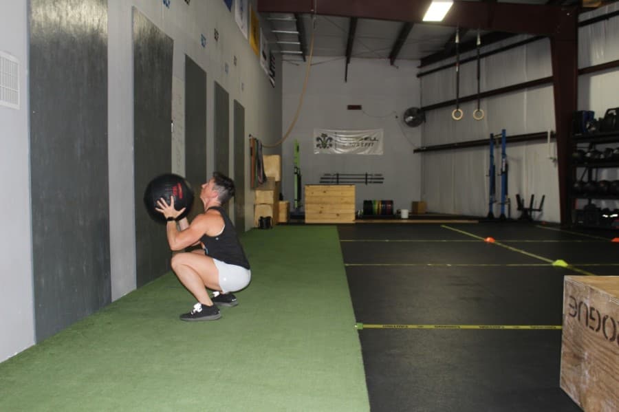 Bombshell CrossFit owner Jennifer Foret demonstrates her warmup routine May 20 (Eva Vigh/Community Impact Newspaper)