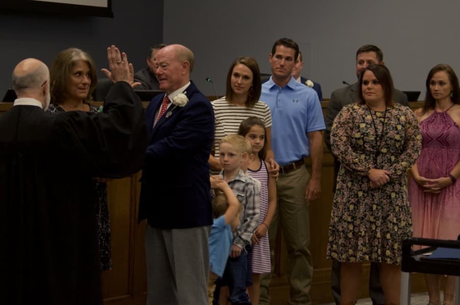 Mayor Rusty Brockman is sworn in with his family standing alongside him at Tuesday's City Council meeting, May 26, 2020. (Warren Brown/Community Impact Newspaper)