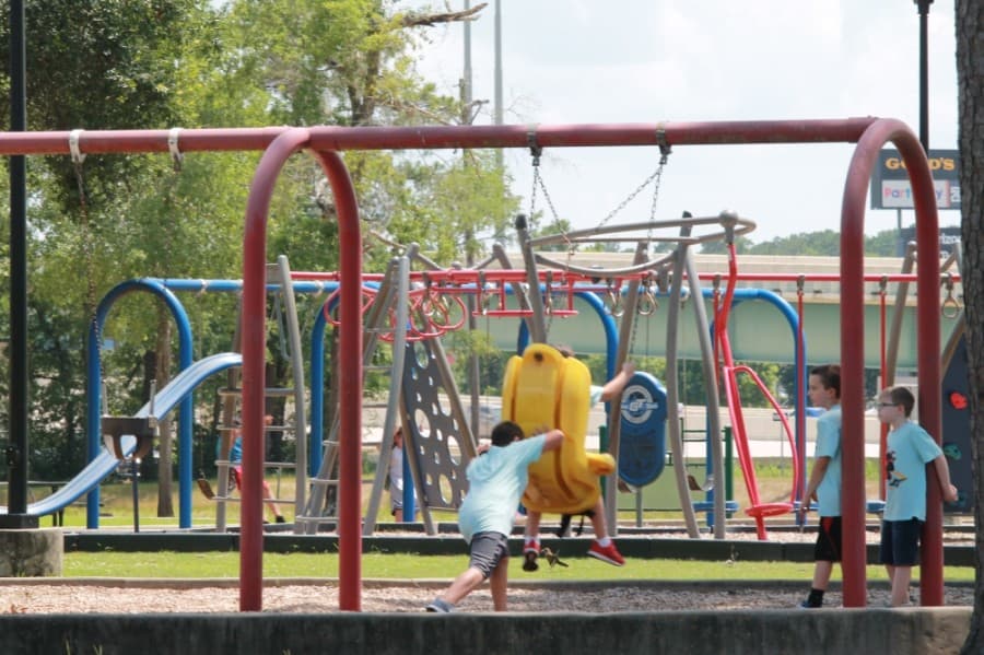 Children play at a playground in Candy Cane Park in Conroe on May 28. (Andy Li/Community Impact Newspaper)