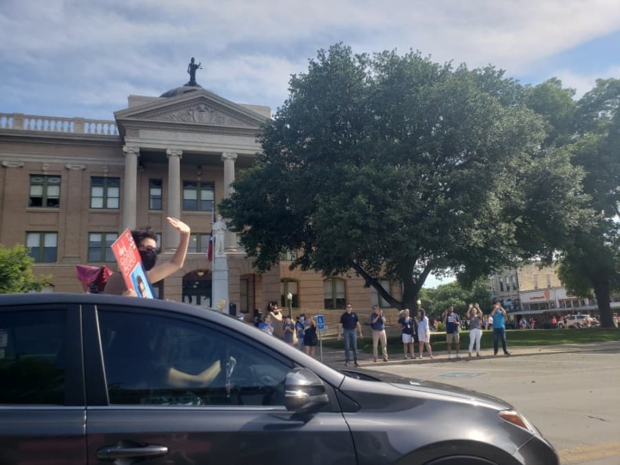 The Georgetown ISD seniors' parade passes the Williamson County Courthouse May 29. (Ali Linan/Community Impact Newspaper)