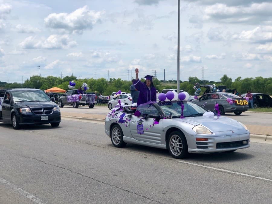 Seniors were encouraged to wear their caps and gowns to the parade. (Evelin Garcia/ Community Impact Newspaper)