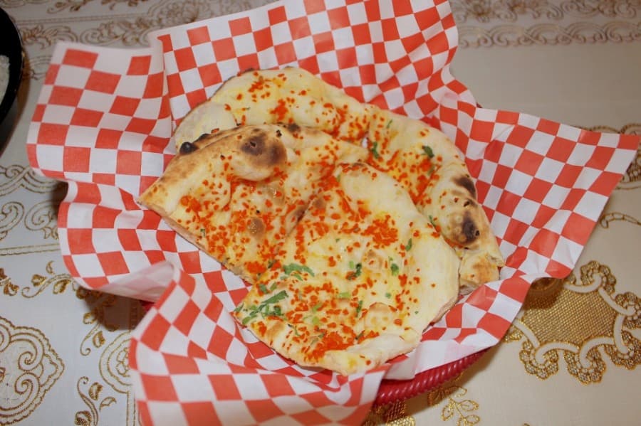 Naan is cooked in the tandoori oven. (Olivia Lueckemeyer/Community Impact Newspaper)