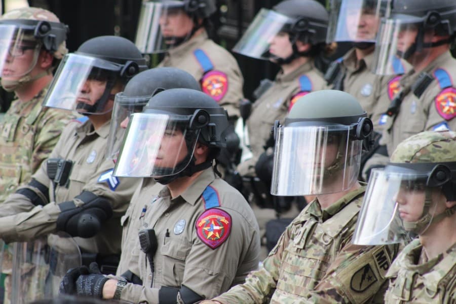 Texas Rangers form a barrier between protesters and the governor's mansion. (Christopher Neely/Community Impact Newspaper)