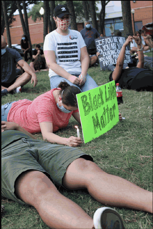 For 8 minutes and 46 seconds, protesters at the Kingwood event lay and sit on the grass of Town Center Park on June 1. (Kelly Schafler/Community Impact Newspaper)
