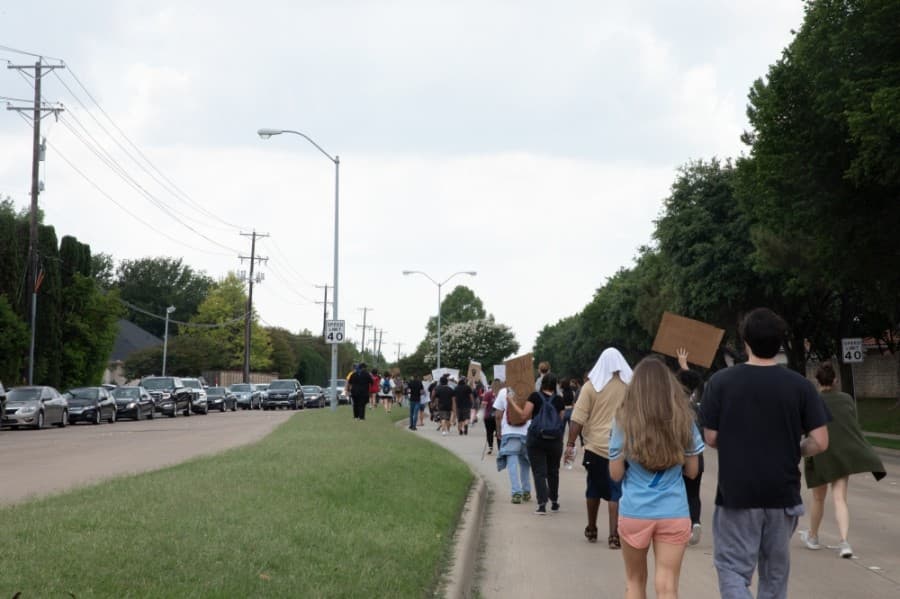 Traffic was moved to one side of the road while marchers made their way down Parker Road. (Liesbeth Powers/Community Impact Newspaper)