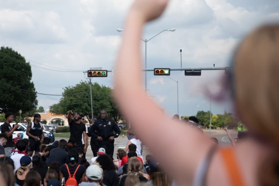 The march ended with a second kneel by protesters at the intersection of Parker and Preston roads. (Liesbeth Powers/Community Impact Newspaper)