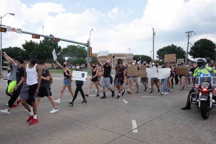 Police assisted in blocking traffic for protesters. A number of marchers turned to say thank you as they passed the officers. (Liesbeth Powers/Community Impact Newspaper)