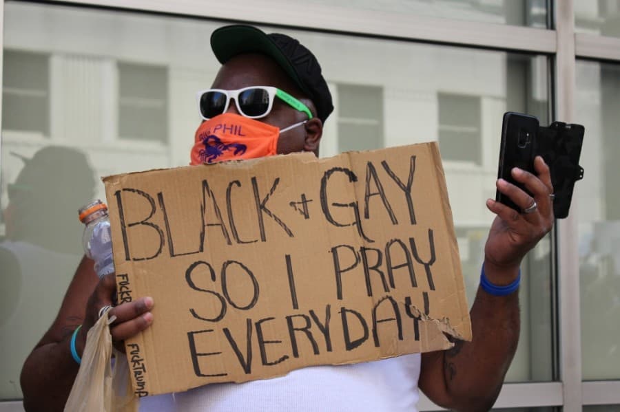 “This wasn’t about me today, this was about justice for [George Floyd] and all of those who have lost their lives at the hands of police brutality but at the same time, [my] sign goes along with it,” demonstrator Phillip Grant said. “I’m a black man and I happen to be a gay man, so, all of my life, I’ve lived a double whammy." (Adriana Rezal/Community Impact Newspaper)