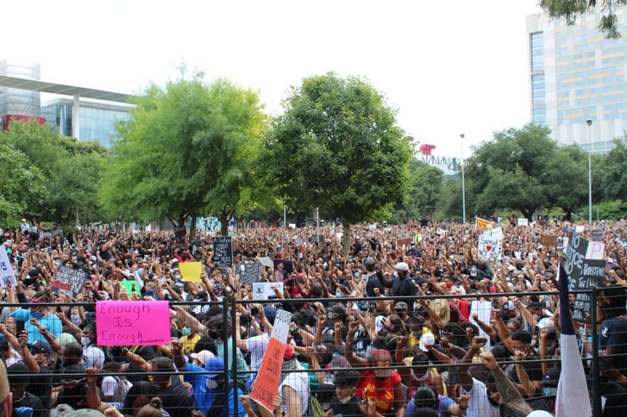 Participants held fists in the air during a moment of silence. (Emma Whalen/Community Impact Newspaper)