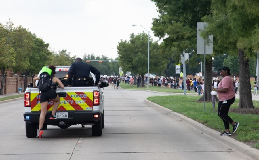 Plano Police Department Chief Ed Drain offered a ride in the back of a city truck to two protesters. (Liesbeth Powers/Community Impact Newspaper)