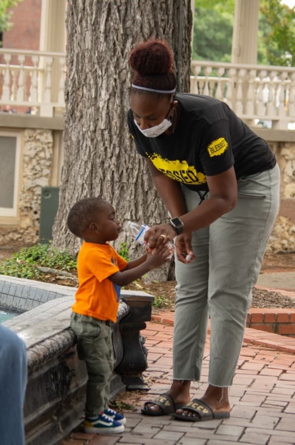 A mother shares a quite moment with her child during the protest. (Warren Brown/Community Impact Newspaper)