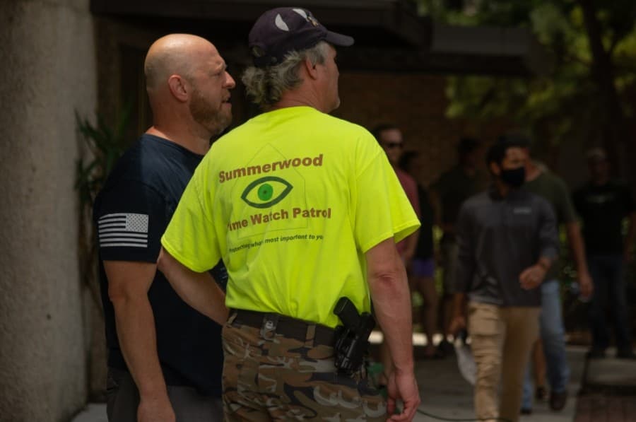 Several protesters and onlookers openly carried firearms during the George Floyd protest in downtown New Braunfels on June 2. (Warren Brown/Community Impact Newspaper)