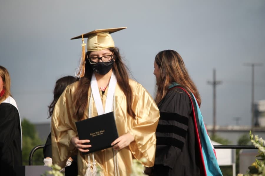 The district officials distributing diplomas wore gloves and graduates did not shake the hands of Principal Rotasha Smith or Superintendent Curtis Null. (Andy Li/Community Impact Newspaper)
