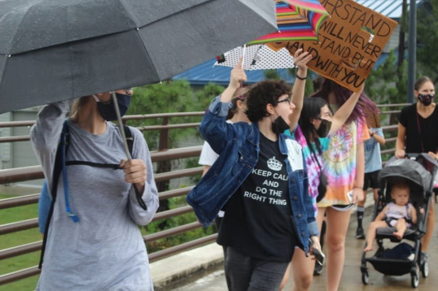 Protestors cheered as a passing vehicle honked in support. (Andrew Christman/Community Impact Newspaper)