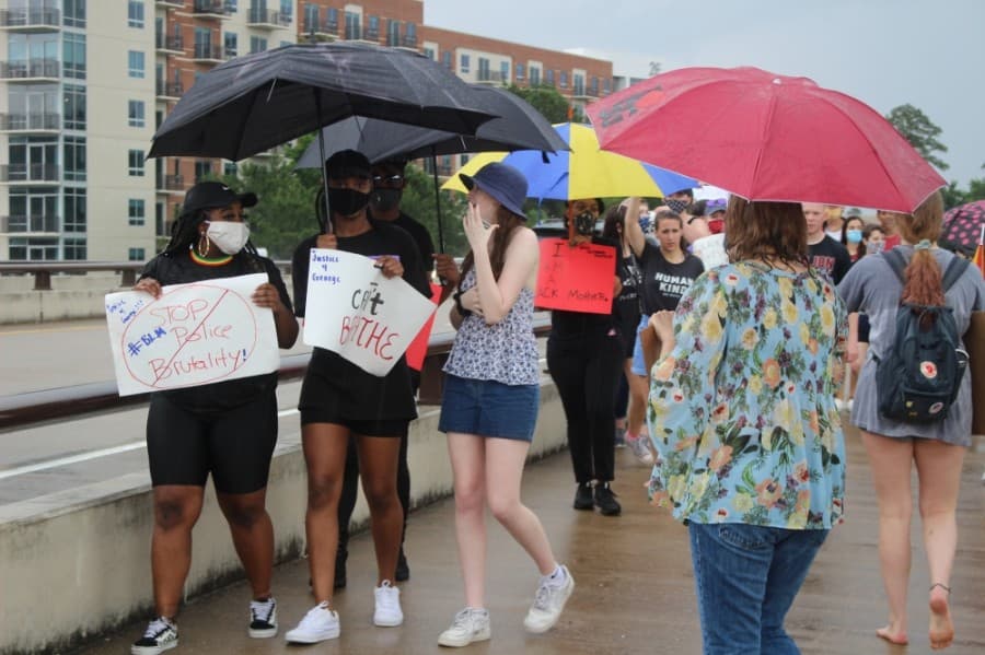 Protestors marched on the Lake Woodlands Drive bridge. (Andrew Christman/Community Impact Newspaper)