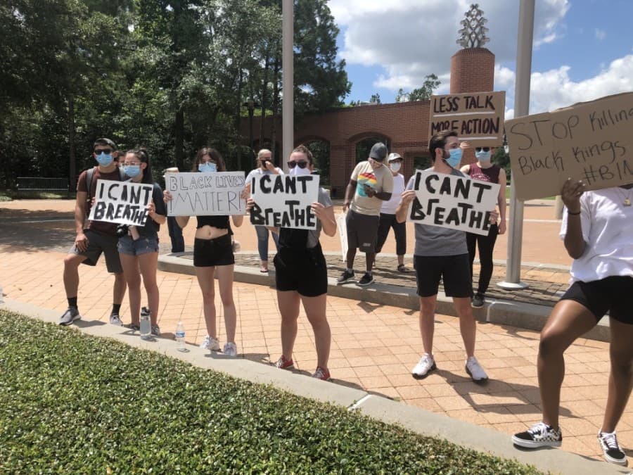 Protestors held up "I Can't Breathe" signs during a June 4 protest. (Andrew Christman/Community Impact Newspaper)