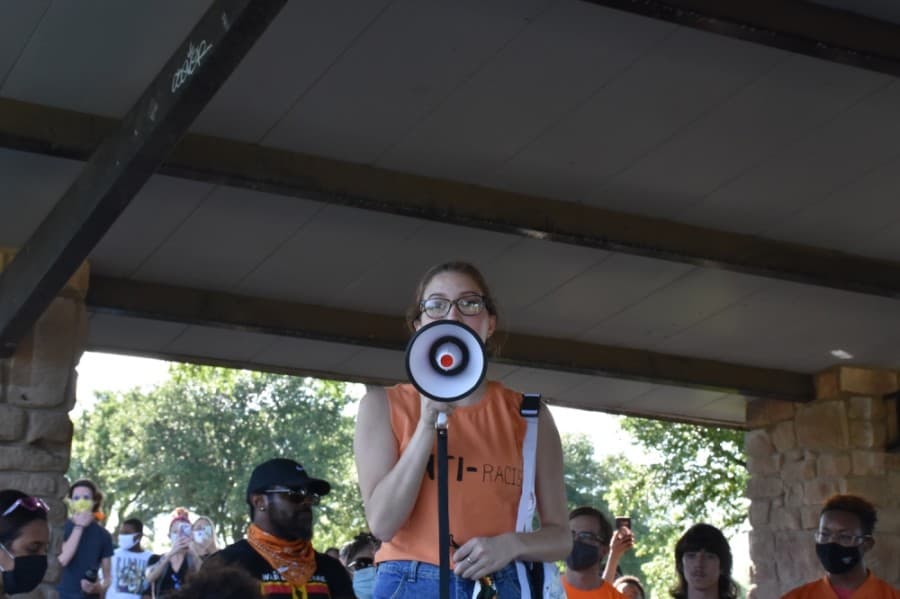 Isabela Marcano, one of the organizers, spoke to the crowd about the purpose of the protest. (Makenzie Plusnick/Community Impact Newspaper)