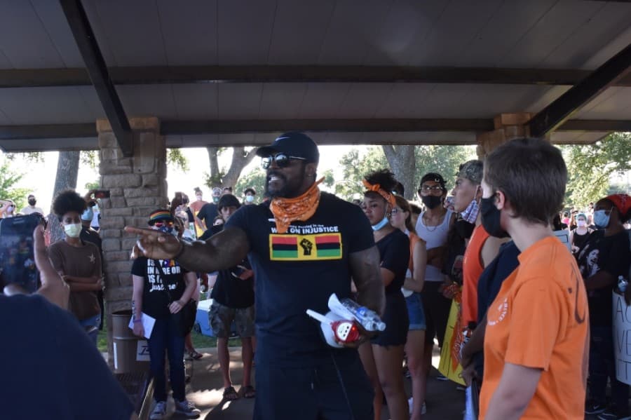 A man who identified himself only as a 13-year teacher in Richardson ISD shared his experience about racism and told the protesters, "They won't chase me out. I'm here for change." (Makenzie Plusnick/Community Impact Newspaper)