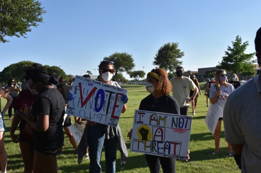 Protesters also used the opportunity to encourage participation at the polls. (Makenzie Plusnick/Community Impact Newspaper)
