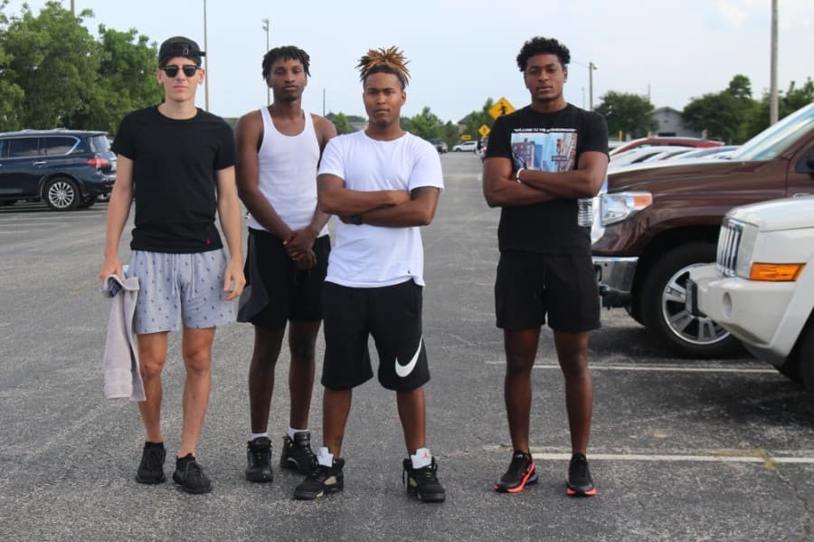 Four demonstrators stand at the parking lot of Katy Park, where the Katy for Black Lives Matter Protest was held June 4.  (Eva Vigh/Community Impact Newspaper)