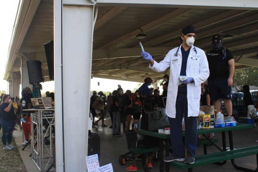 A health care professional handed out face masks at the Katy for Black Lives Matter Protest held June 4 at Katy Park. (Jen Para/Community Impact Newspaper)