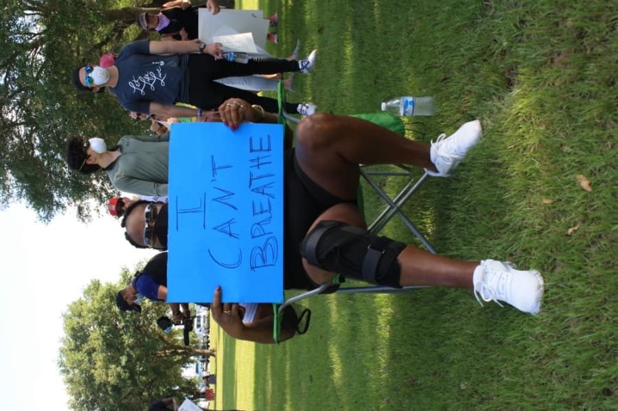 A Katy for Black Lives Matter Protest attendee sat in the shade before the march began June 4 at Katy Park. (Jen Para/Community Impact Newspaper)