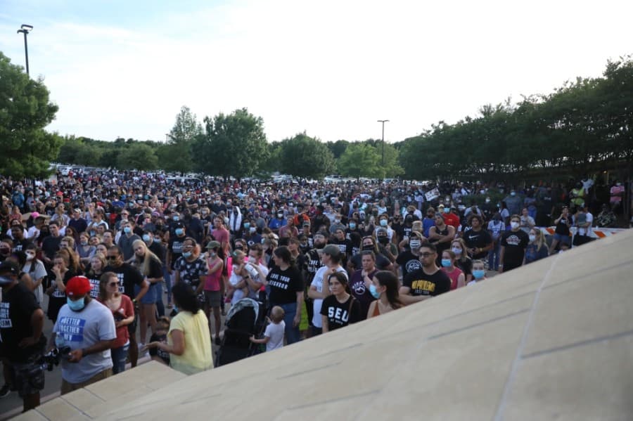 The parking lot in front of the Collin County Courthouse was filled along with a large portion of the two-way strip of road between the parking areas during the gathering. (Liesbeth Powers/Community Impact Newspaper)