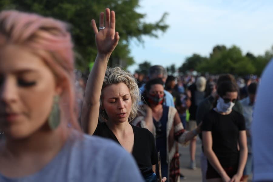 Those in the crowd lifted their hands during prayer at the June 4 prayer rally. (Liesbeth Powers/Community Impact Newspaper)