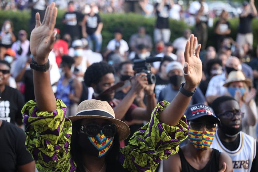 Those in the crowd lifted their hands during prayer at the June 4 prayer rally. (Liesbeth Powers/Community Impact Newspaper)