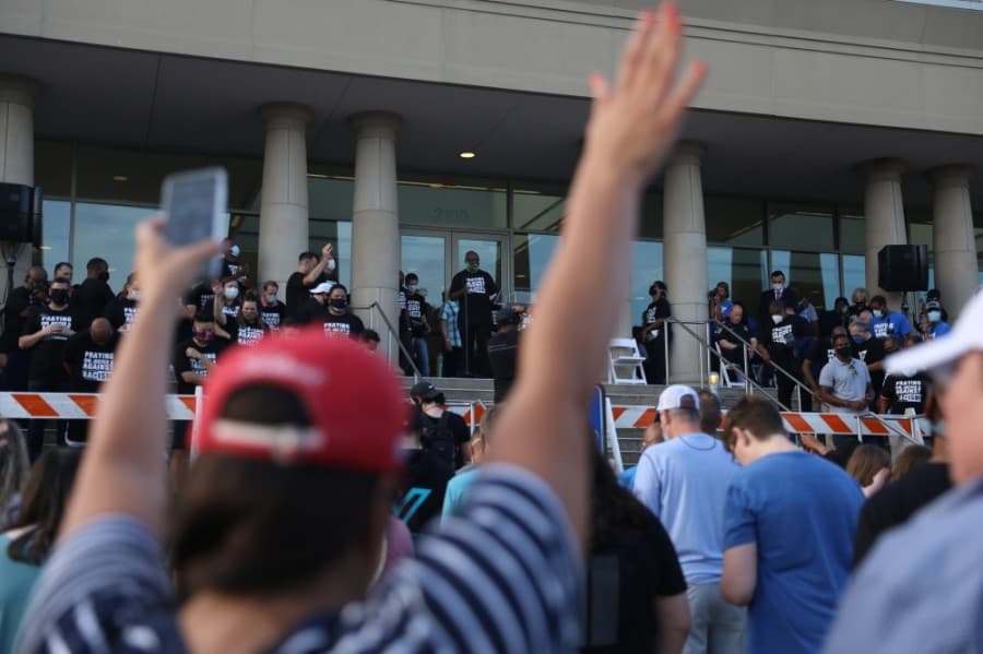 Dr. Louis Rosenthal, pastor at The McKinney First Baptist Church, prays over the crowd at the Collin County Courthouse. (Liesbeth Powers/Community Impact Newspaper)