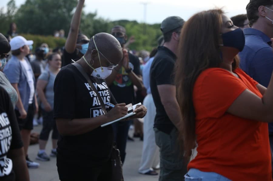 Dawn Stephens, member of One Community Church, took down notes from the multiple short sermons given on racism and injustice. (Liesbeth Powers/Community Impact Newspaper)