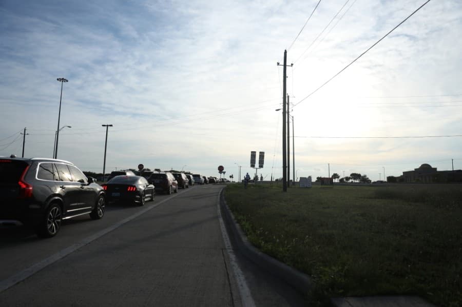 A line of cars waited along Bloomdale Road and N. Central Expressway as the event began at 7 p.m. June 4. (Liesbeth Powers/Community Impact Newspaper)