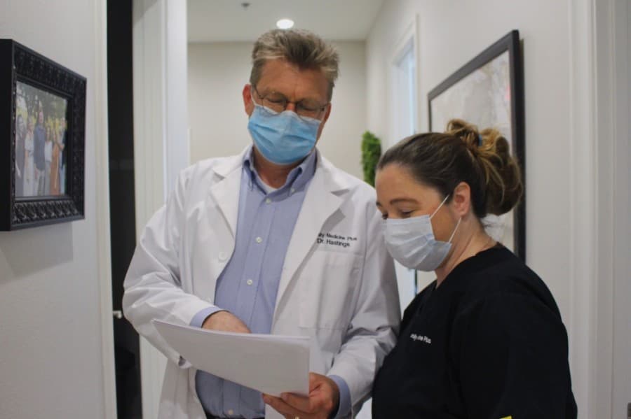 Dr. Scott Hastings consults with a nurse at Family Medicine Plus in Frisco. (Courtesy Family Medicine Plus)