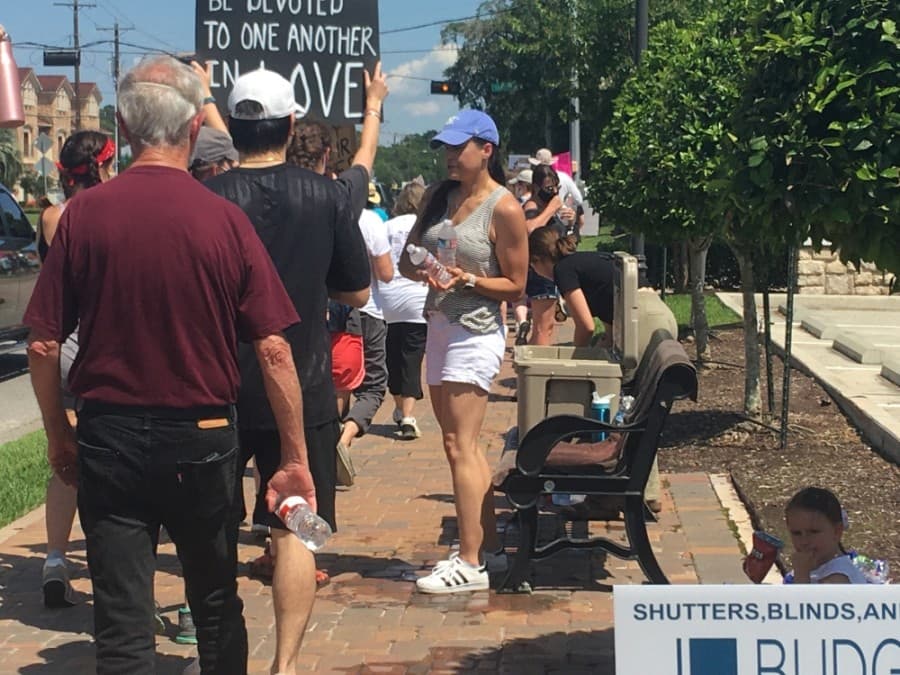 Some handed out water to protesters during the march. (Haley Morrison/Community Impact Newspaper)