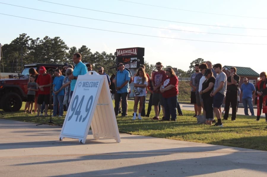 Members of the Magnolia community gathered to pray June 5 for unity amid unrest in the nation. Some gathered on the lawn in front of Magnolia High School while others stayed in their vehicles, listening in via an FM transmitter. (Anna Lotz/Community Impact Newspaper)