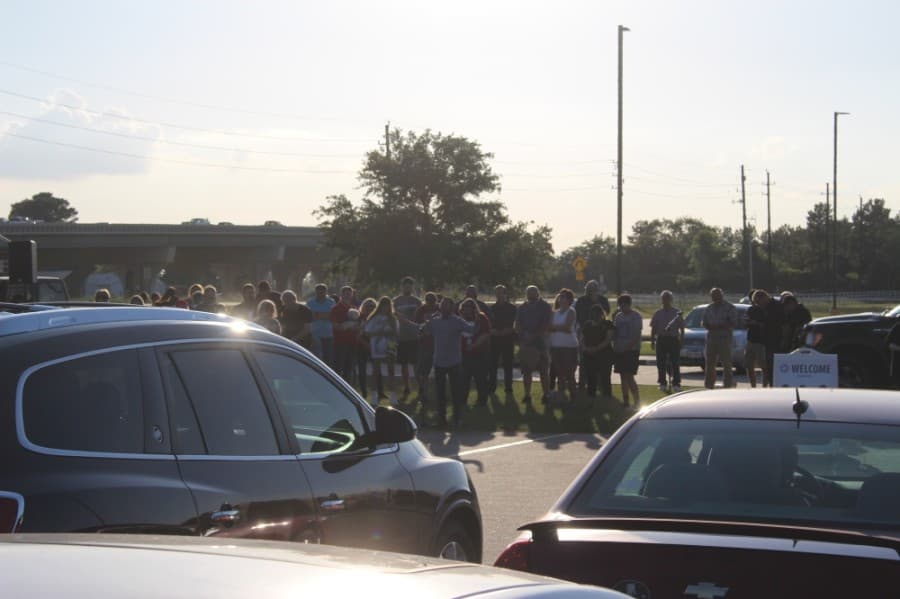 The prayer rally attracted a few dozen community members on June 5. Attendees could gather on the lawn or listen in from their vehicles. (Dylan Sherman/Community Impact Newspaper)