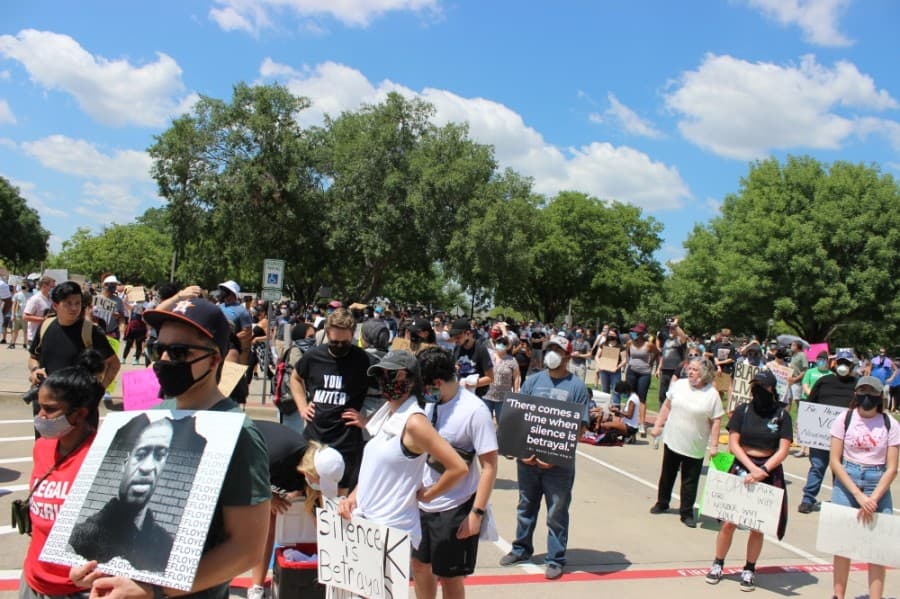 Plano protesters on June 7 hold signs depicting messages in support of police reform, as well as the image of George Floyd (left), who died in police custody in Minneapolis. (Daniel Houston/Community Impact Newspaper)