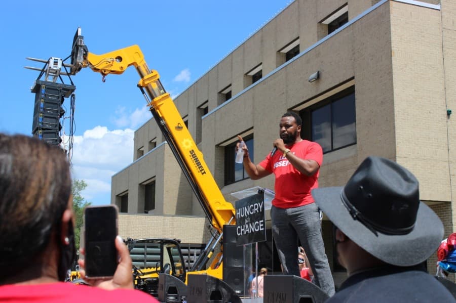 Lee Merritt, a Plano resident and attorney for the family of Ahmaud Arbery, addresses the crowd at a June 7 rally for police reform in downtown Plano. (Daniel Houston/Community Impact Newspaper)
