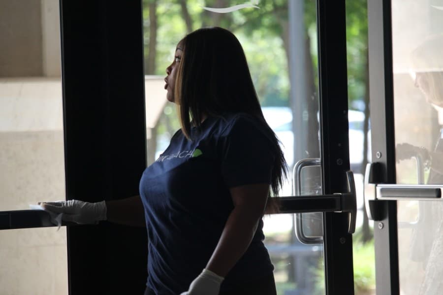 A church worker clears a door. (Andy Li/Community Impact Newspaper)