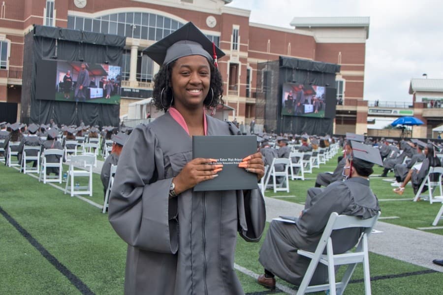 A Cypress Lakes High School graduate holds up her diploma at a June 3 graduation ceremony. (Courtesy Cy-Fair ISD)