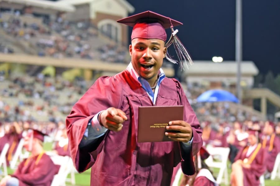 A Cy-Fair High School graduate holds up his diploma at a June 1 ceremony. (Courtesy Cy-Fair ISD)