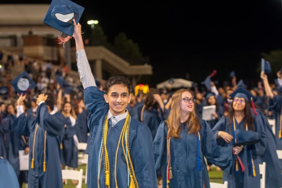 A Cypress Springs High School graduate raises his cap in the air at a June 4 ceremony. (Courtesy Cy-Fair ISD)