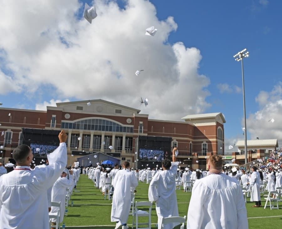 Cypress Ridge High School graduates toss their caps in the air in celebration at the end of a June 4 ceremony. (Courtesy Cy-Fair ISD)