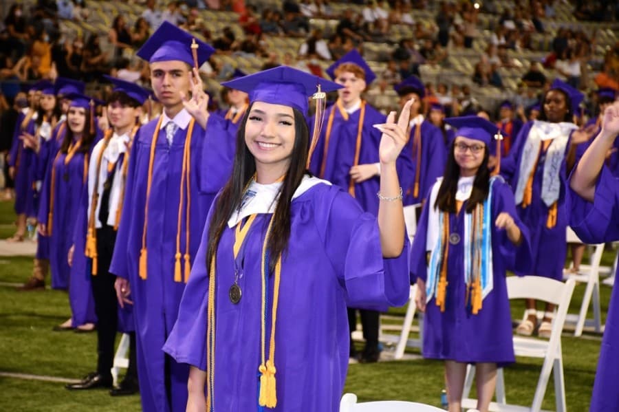 A Jersey Village High School graduate forms the letters "J" and "V" with her hand at a June 5 ceremony. (Courtesy Cy-Fair ISD)