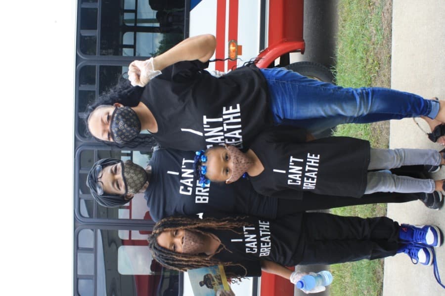 Meryl Kizzel (far right) came to the public memorial event with her mother and children. (Jen Para/Community Impact Newspaper)