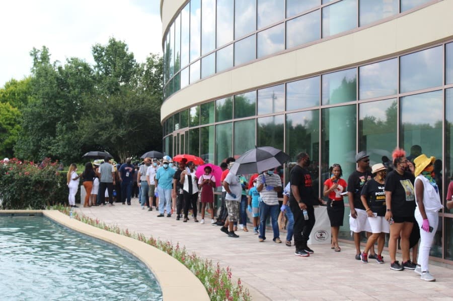Because of social distancing measures, only 10 attendees were allowed in the church at a time, so a line formed, which wrapped around the church and yard. (Claire Shoop/Community Impact Newspaper)