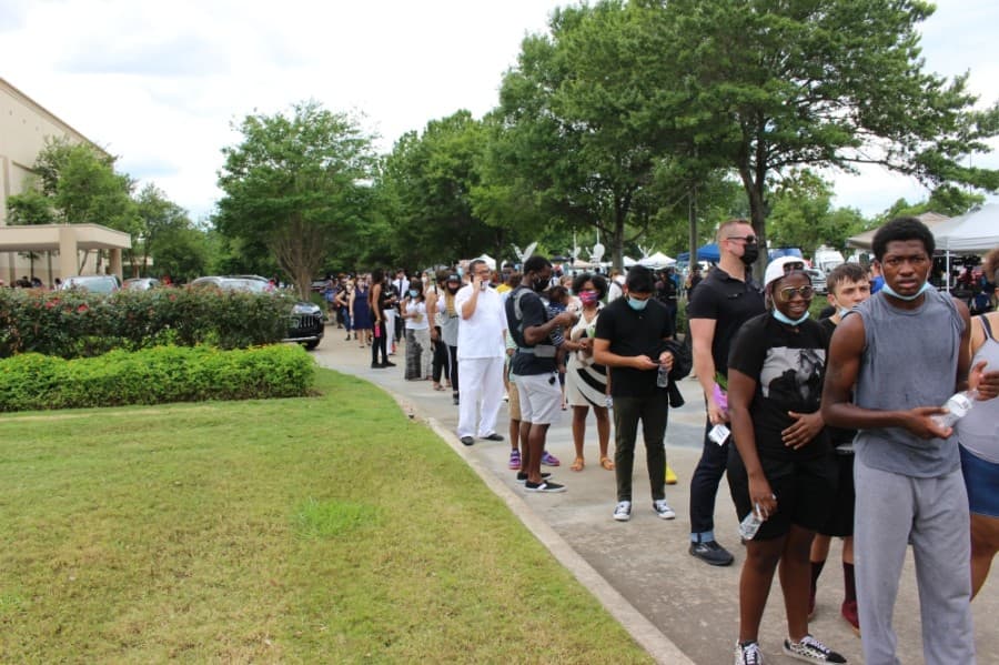 Because of social distancing measures, only 10 attendees were allowed in the church at a time, so a line formed, which wrapped around the church and yard. (Beth Marshall/Community Impact Newspaper)