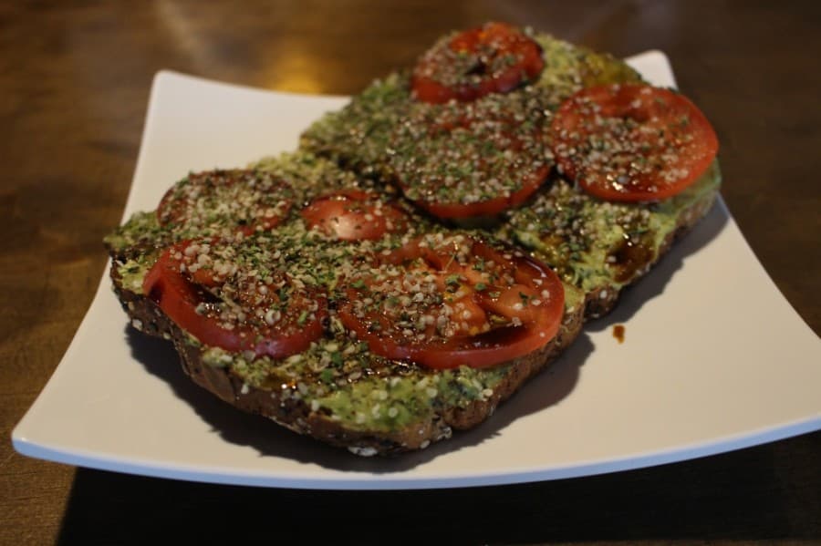 Power toast consists of whole-grain toast, avocado spread, tomato slices, balsamic vinegar and hemp seeds. (Andrew Christman/Community Impact Newspaper)