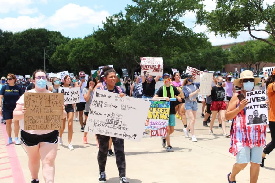 Protesters march passed Keller Town Hall during a George Floyd protest on June 7. (Ian Pribanic/Community Impact Newspaper)